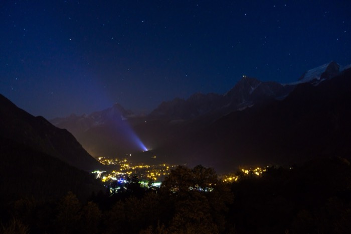 Chamonix valley lights at night beneath dark mountains